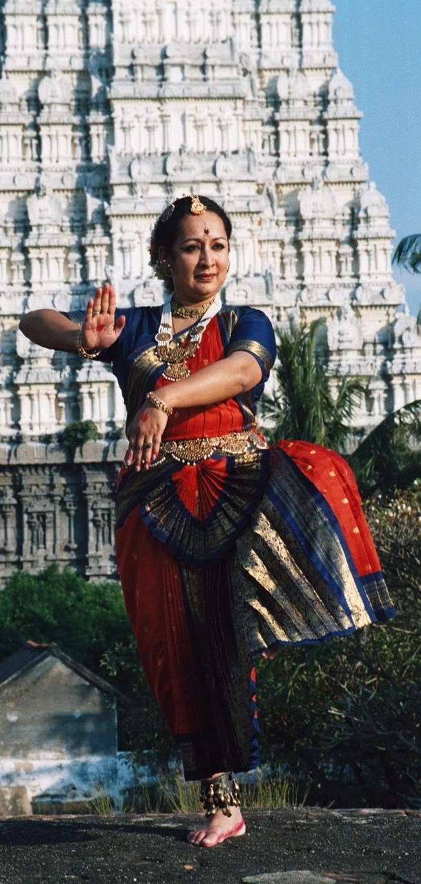 Swati Gupté Bhisé dancing in front of a South Indian temple gopuram